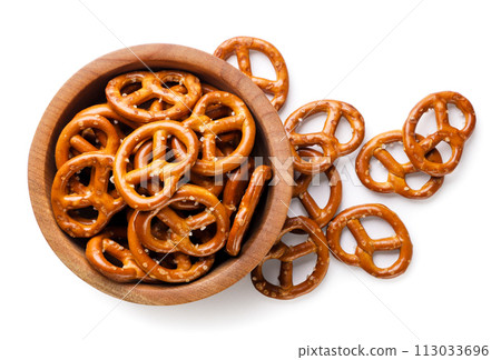 Pretzels in a plate and scattered close-up on a white. Top view 113033696