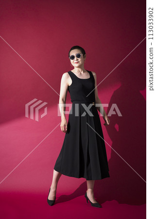 A woman in a black dress 113033902