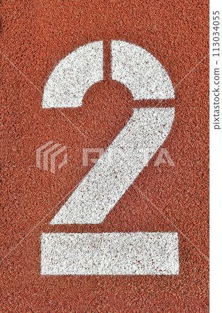 Number two on a red runway is numbered at a stadium Number two on a red runway is numbered at a stadium 113034055