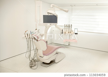 Pink dental chair in a modern dental office Pink dental chair in a modern dental office 113034059