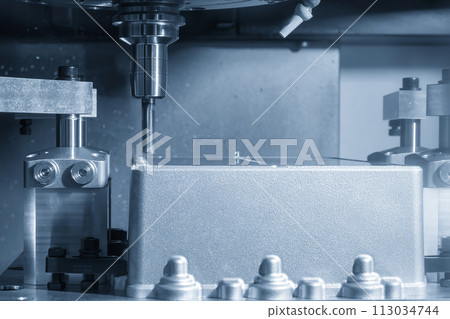The CNC milling machine cutting mold parts with flat end mill tool in the light blue scene. The CNC milling machine cutting mold parts with flat end mill tool in the light blue scene. 113034744