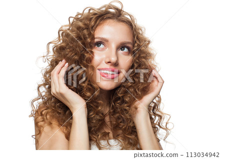 Pretty good-looking redhead woman with clean skin, curly hairstyle and natural make-up. Female model Pretty good-looking redhead woman with clean skin, curly hairstyle and natural make-up. Female model 113034942