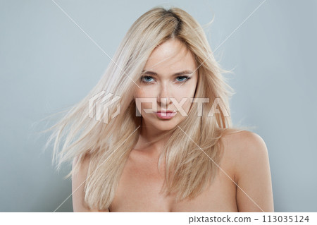 Blond fashion female model with long blonde hairstyle and shiny fresh skin  113035124