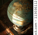 A hyperrealistic close-up of a world globe on a classroom desk 113036112