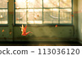 A photo of a single colorful origami crane suspended mid-air in an empty classroom 113036120