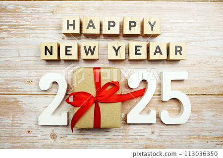 Happy New Year 2025 alphabet letters and gift box presents on wooden background 113036350