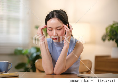 Asian college students are stressed out Sitting in front of a laptop studying online through a video calling program on a laptop at home. 113036541