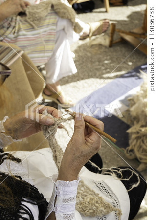 Detail of old tradition, weaving clothes by hand in a traditional way Detail of old tradition, weaving clothes by hand in a traditional way 113036738