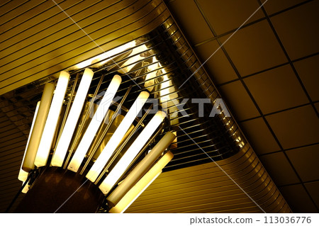 Lamps in subway kyiv Yellow light with reflections on metal parts of interior 113036776