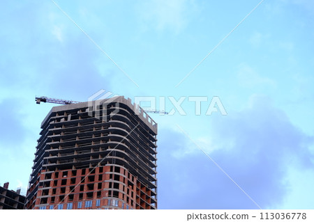Low angle view of modern office building by construction site against sky in city Low angle view of modern office building by construction site against sky in city 113036778