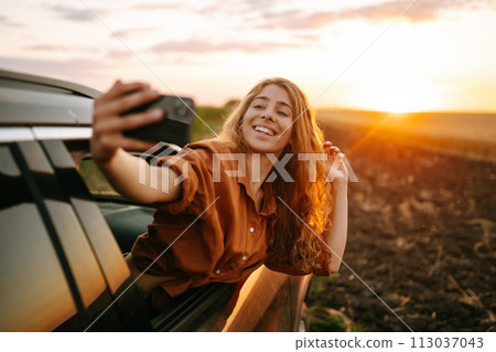 Towards adventure! Woman is resting and enjoying trip in car. Lifestyle, travel, tourism, nature. 113037043