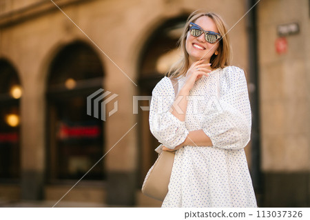 Young beautiful woman walking the streets of an Italian town. Travel and tourism concept. 113037326