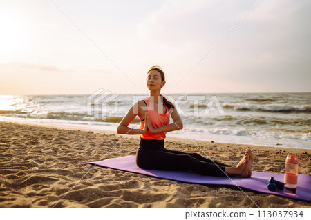 Young woman in sportswear doing yoga, fitness exerciseon the beach. Sport, Active life. Young woman in sportswear doing yoga, fitness exerciseon the beach. Sport, Active life. 113037934