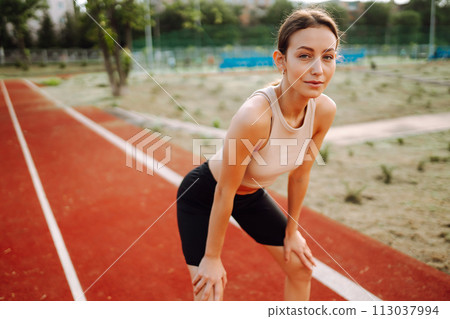 Sport woman doing exercises outdoors in morning. Active life, sports training, healthy lifestyle. 113037994