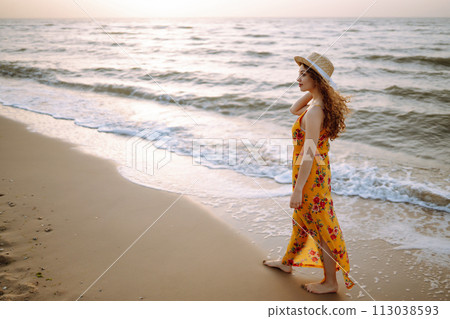 Stylish woman in elegant dress posing near the sea. Summer time. Travel, weekend, relax. 113038593