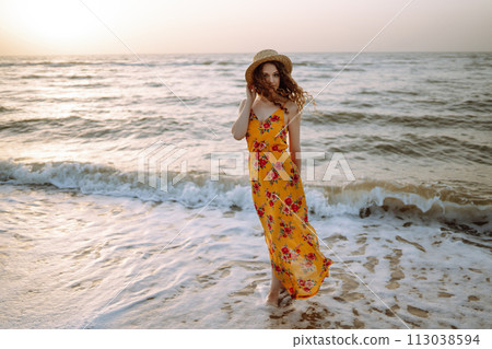 Stylish woman in elegant dress posing near the sea. Summer time. Travel, weekend, relax. 113038594