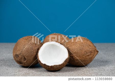 Coconuts on blue background, space for text Coconuts on blue background, space for text 113038660