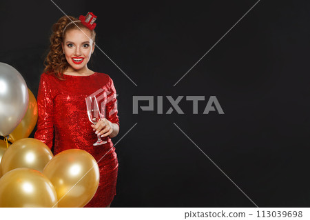 Excited happy surprised woman with makeup and hairstyle wearing red shiny sequins dress 113039698