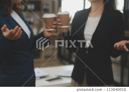 Entrepreneur Asian businessman and businesswoman discussing new business project in tablet in modern Meeting In Modern Office, Asian business casual concept. 113040058