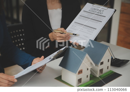 Business Signing a Contract Buy - sell house, insurance agent analyzing about home investment loan Real Estate concept. 113040066