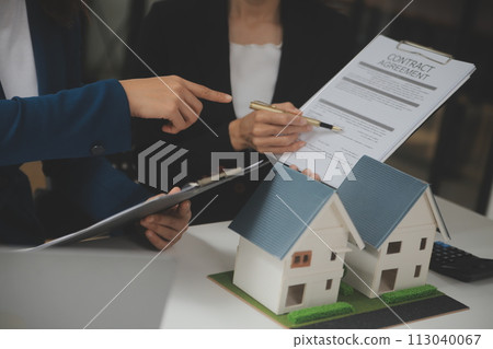 Business Signing a Contract Buy - sell house, insurance agent analyzing about home investment loan Real Estate concept. 113040067