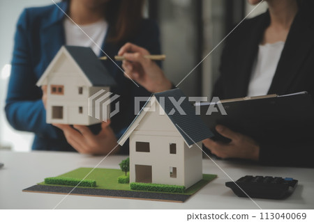 Business Signing a Contract Buy - sell house, insurance agent analyzing about home investment loan Real Estate concept. 113040069