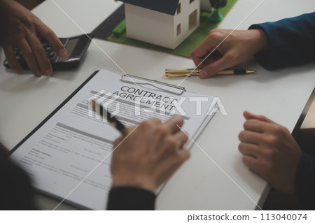 Business Signing a Contract Buy - sell house, insurance agent analyzing about home investment loan Real Estate concept. 113040074