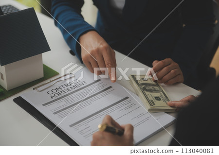 Business Signing a Contract Buy - sell house, insurance agent analyzing about home investment loan Real Estate concept. Business Signing a Contract Buy - sell house, insurance agent analyzing about home investment loan Real Estate concept. 113040081