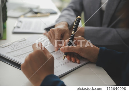 Business Signing a Contract Buy - sell house, insurance agent analyzing about home investment loan Real Estate concept. Business Signing a Contract Buy - sell house, insurance agent analyzing about home investment loan Real Estate concept. 113040098