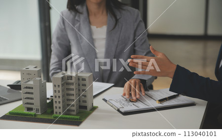 Business Signing a Contract Buy - sell house, insurance agent analyzing about home investment loan Real Estate concept. Business Signing a Contract Buy - sell house, insurance agent analyzing about home investment loan Real Estate concept. 113040101