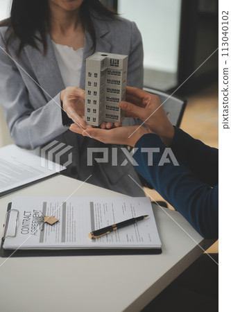 Business Signing a Contract Buy - sell house, insurance agent analyzing about home investment loan Real Estate concept. 113040102