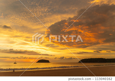 .beautiful cloud in golden sky at sunset in Kata beach Phuket Thailand. 113040162