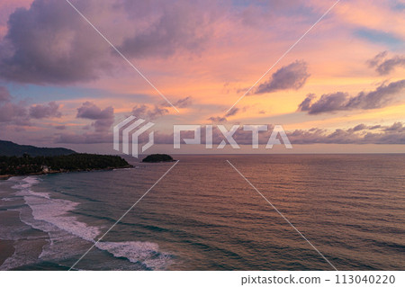 .aerial view Wave after wave swept towards the shore at sunset. 113040220