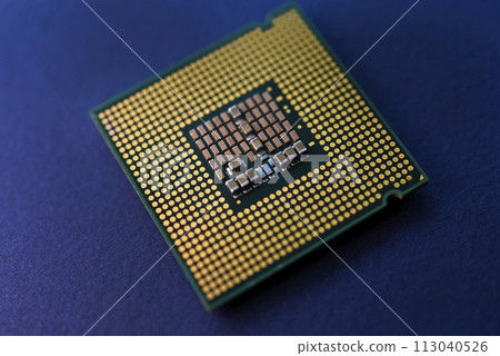 A computer processor on a blue background. Contacts on the processor case. 113040526