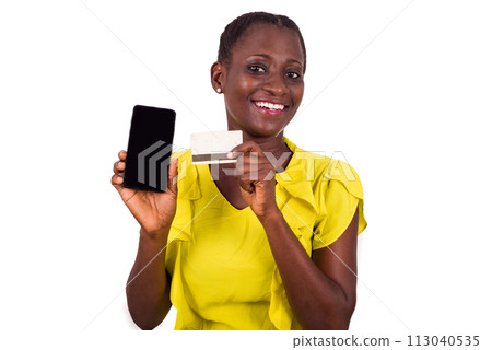 young woman holding a new credit card with a mobile phone 113040535