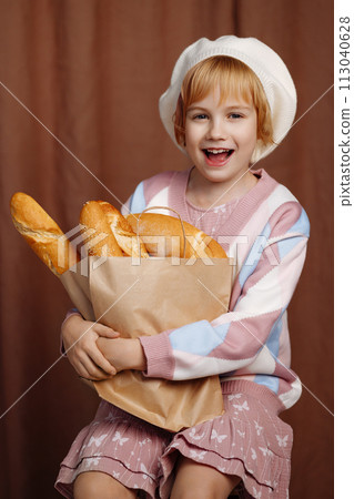 Girl holding bag full of bread. 113040628