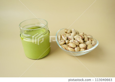 top view a pistachios cream and nuts in a bowl top view a pistachios cream and nuts in a bowl 113040663