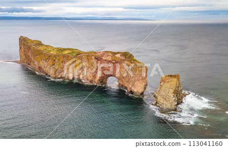 Town on the Atlantic Ocean Coast during a cloudy sunset. Perce, Quebec, Canada. 113041160