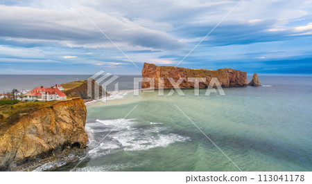 Town on the Atlantic Ocean Coast during a cloudy sunset. Perce, Quebec, Canada. 113041178