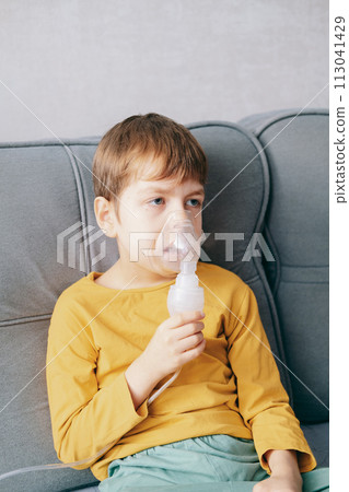 little boy sits with an inhalation mask during cough and bronchitis. Treatment with an inhaler at home little boy sits with an inhalation mask during cough and bronchitis. Treatment with an inhaler at home 113041429