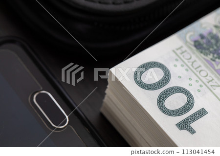 Polish paper banknotes with a face value of PLN 100 are the official currency of the country and are on the table. Polish paper banknotes with a face value of PLN 100 are the official currency of the country and are on the table. 113041454