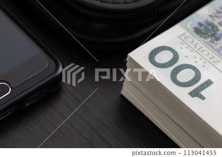Polish paper banknotes with a face value of PLN 100 are the official currency of the country and are on the table. Polish paper banknotes with a face value of PLN 100 are the official currency of the country and are on the table. 113041455