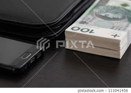 Polish paper banknotes with a face value of PLN 100 are the official currency of the country and are on the table. Polish paper banknotes with a face value of PLN 100 are the official currency of the country and are on the table. 113041456