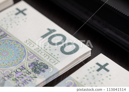 Polish paper banknotes stacked on the table, ready to start the transaction. Polish paper banknotes stacked on the table, ready to start the transaction. 113041514