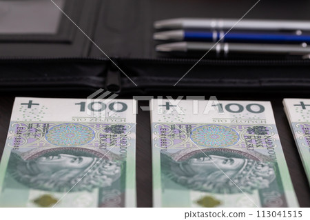Polish paper banknotes stacked on the table, ready to start the transaction. Polish paper banknotes stacked on the table, ready to start the transaction. 113041515