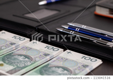 Polish paper banknotes stacked on the table, ready to start the transaction. Polish paper banknotes stacked on the table, ready to start the transaction. 113041516