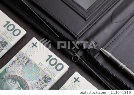 Polish paper banknotes stacked on the table, ready to start the transaction. Polish paper banknotes stacked on the table, ready to start the transaction. 113041519