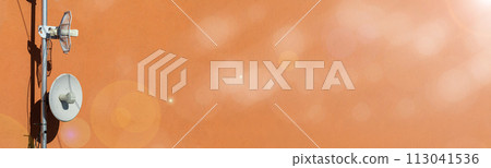 Two telecommunications antennas used for cellular network and wireless Internet, fixed on the building wall. Receiving and digitizing multiple pieces of information at once. Panoramic frame. Bokeh Two telecommunications antennas used for cellular network and wireless Internet, fixed on the building wall. Receiving and digitizing multiple pieces of information at once. Panoramic frame. Bokeh 113041536