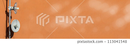 Two telecommunications antennas used for cellular network and wireless Internet, fixed on the building wall. Receiving and digitizing multiple pieces of information at once. Panoramic frame. Bokeh 113041548