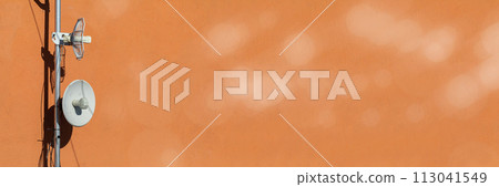 Two telecommunications antennas used for cellular network and wireless Internet, fixed on the building wall. Receiving and digitizing multiple pieces of information at once. Panoramic frame. Bokeh 113041549